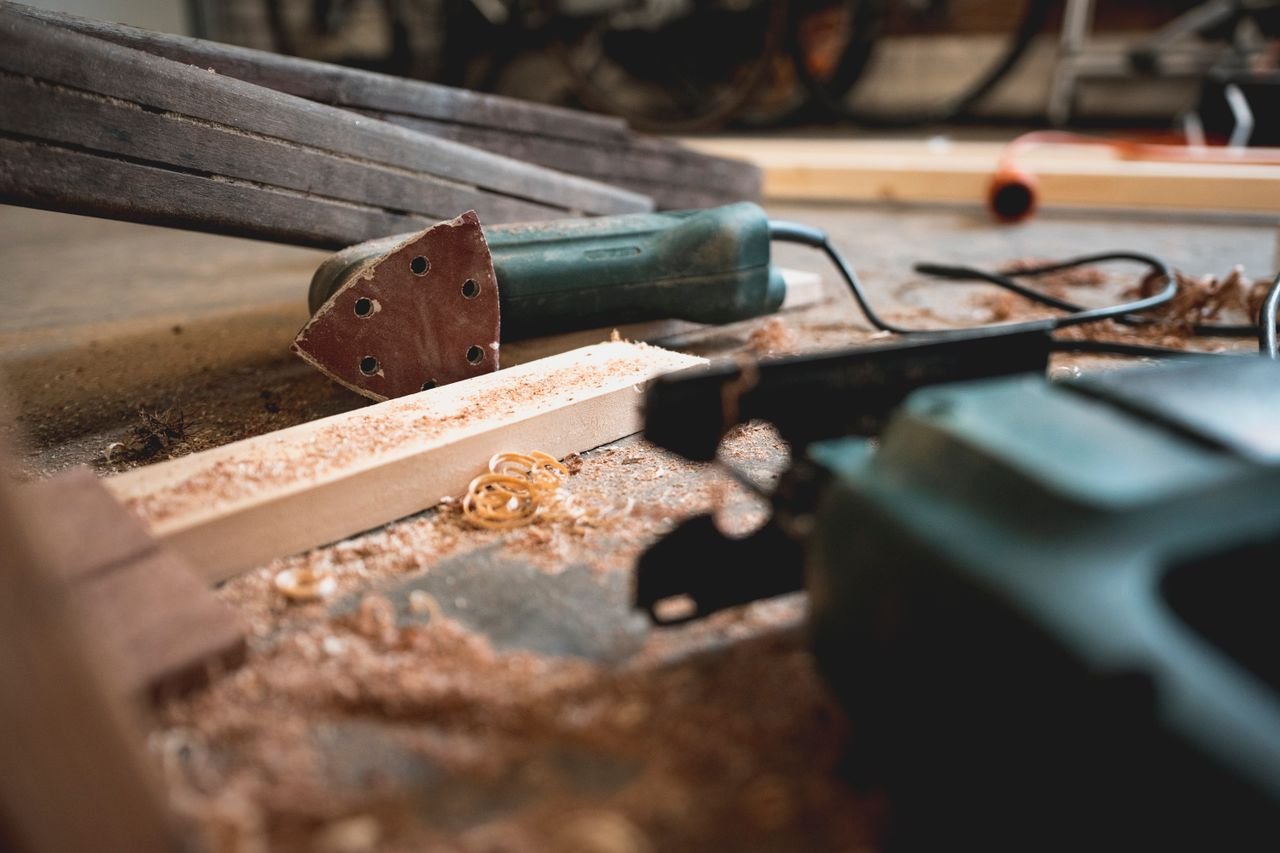 The Art of Drawing Readers In: Your attractive post title goes here Close-up of various woodworking tools in a workshop, featuring wood shavings and equipment.